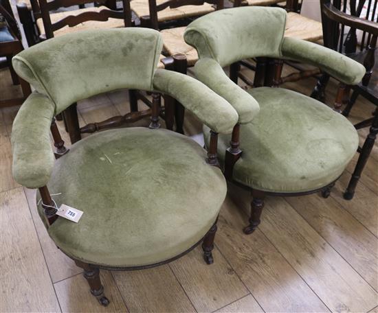 A pair of upholstered tub chairs